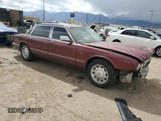 1998 Jaguar XJ Vanden Plas with VIN SAJKX6245WC830912, listed as a Copart auction lot 49717285 with 127,509 mi miles and Salvage Title. Bid and sale history available at DreamBid. Image 4.