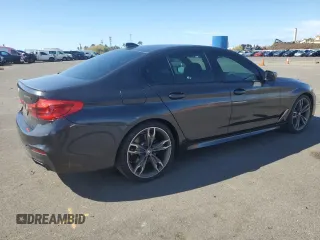 2019 BMW 5 Series M550i xDrive with VIN WBAJB9C57KB289036, listed as a Copart auction lot 86292134 with 28,103 mi miles and Salvage title. Bid and sale history available at DreamBid. Image 3.