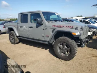 2023 Jeep Gladiator Rubicon with VIN 1C6JJTBG8PL550219, listed as a Copart auction lot 54627685 with 9,671 mi miles and Salvage title. Bid and sale history available at DreamBid. Image 4.