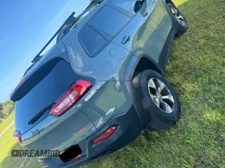 2015 Jeep Cherokee Trailhawk with VIN 1C4PJMBS1FW529559, listed as a Copart auction lot 66581755 with 113,915 mi miles and Salvage title. Bid and sale history available at DreamBid. Image 4.
