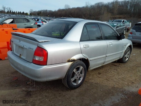 2003 Mazda Protege DX with VIN JM1BJ225830202261, listed as a IAAI auction lot 41273338 with 163,003 mi miles. Bid and sale history available at carsss.com. Image 4.