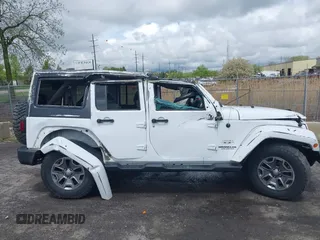 2016 Jeep Wrangler Unlimited Sahara with VIN 1C4BJWEG8GL129577, listed as a IAAI auction lot 42184373 with 185,761 mi miles and . Bid and sale history available at DreamBid. Image 12.