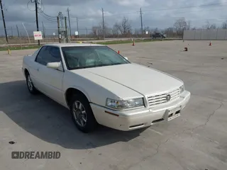 2002 Cadillac Eldorado Touring ETC z VIN 1G6ET12962B105442, wystawiony jako IAAI lot #41736540 z przebiegiem 148 429 mil mil oraz . Historia ofert i sprzedaży dostępna na DreamBid. Obrazek 1.