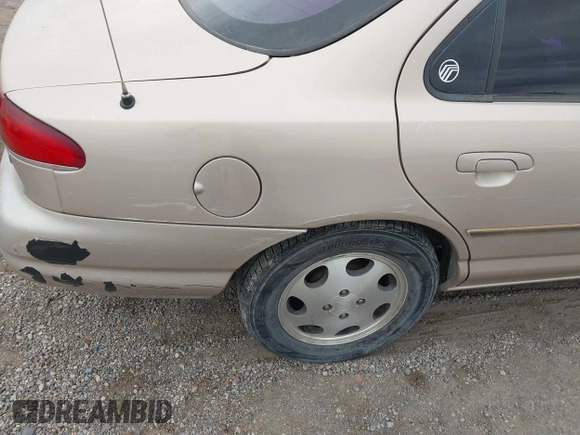 1999 Mercury Mystique GS z VIN 1MEFM6538XK606647, wystawiony jako IAAI lot #41613999 z przebiegiem 90 978 mil mil oraz . Historia ofert i sprzedaży dostępna na DreamBid. Obrazek 6.