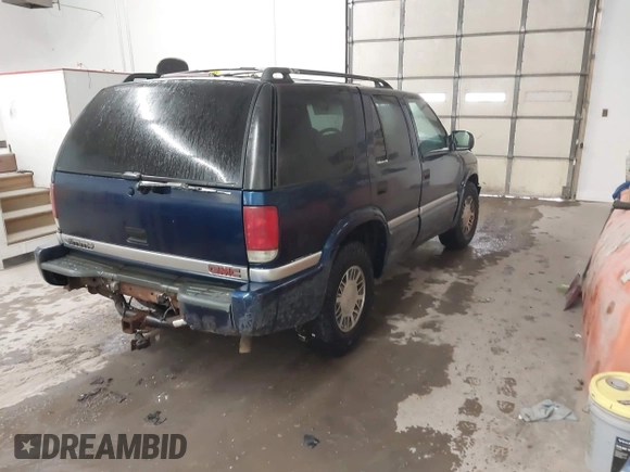 1999 GMC Jimmy SLE z VIN 1GKDT13W8X2534672, wystawiony jako IAAI lot #41562434 z przebiegiem 240 145 mil mil oraz . Historia ofert i sprzedaży dostępna na DreamBid. Obrazek 4.
