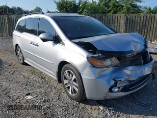 2014 Honda Odyssey Touring with VIN 5FNRL5H95EB108427, listed as a IAAI auction lot 39992643 with 100,658 mi miles and . Bid and sale history available at DreamBid. Image 1.
