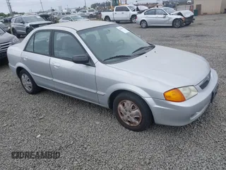 2000 Mazda Protege DX z VIN JM1BJ2225Y0211691, wystawiony jako IAAI lot #42464257 z przebiegiem 176 457 mil mil oraz . Historia ofert i sprzedaży dostępna na DreamBid. Obrazek 1.