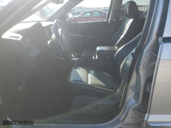 2010 Jeep Grand Cherokee Laredo with VIN 1J4RR4GT1AC106990, listed as a Copart auction lot 87421664 with 106,025 mi miles and Salvage Title. Bid and sale history available at carsss.com. Image 7.