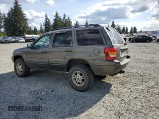 1999 Jeep Grand Cherokee Limited with VIN 1J4GW68S2XC677334, listed as a Copart auction lot 74152054 with 242,220 mi miles and Salvage Title. Bid and sale history available at carsss.com. Image 2.