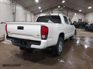 2023 Toyota Tacoma 4WD SR with VIN 3TMCZ5AN7PM571924, listed as a IAAI auction lot 41219097 with 34,292 mi miles. Bid and sale history available at carsss.com. Image 4.
