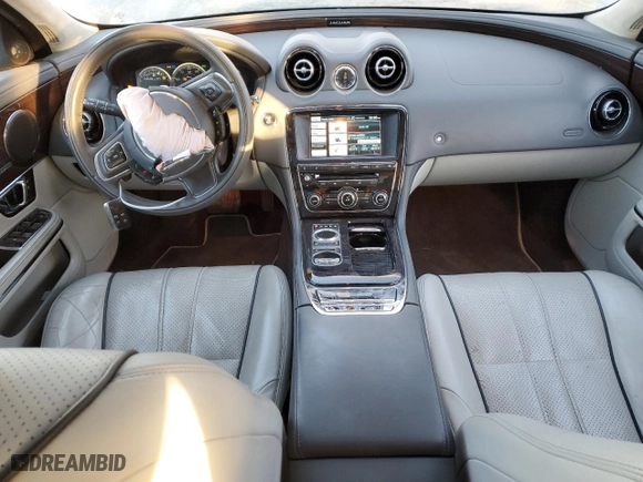 2014 Jaguar XJ with VIN SAJWJ2GD5E8V69562, listed as a Copart auction lot 87737195 with 100,525 mi miles and Salvage Title. Bid and sale history available at carsss.com. Image 8.