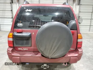 1999 Suzuki Vitara JX z VIN 2S3TD52V4X6110057, wystawiony jako Copart lot #87752215 z przebiegiem 245 419 mil mil oraz Szkody całkowita. Historia ofert i sprzedaży dostępna na DreamBid. Obrazek 6.
