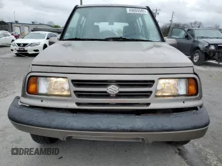 1997 Suzuki Sidekick JX z VIN 2S3TD03V4V6403519, wystawiony jako Copart lot #49666085 z przebiegiem 54 577 mil mil oraz Szkoda całkowita • Salvage title. Historia ofert i sprzedaży dostępna na DreamBid. Obrazek 5.
