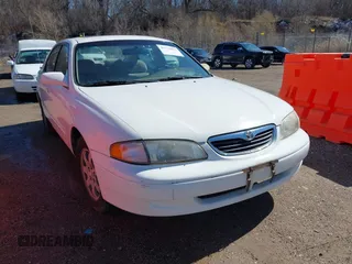 1998 Mazda 626 DX with VIN 1YVGF22CXW5702980, listed as a IAAI auction lot 41778063 with 104,672 mi miles. Bid and sale history available at carsss.com. Image 1.