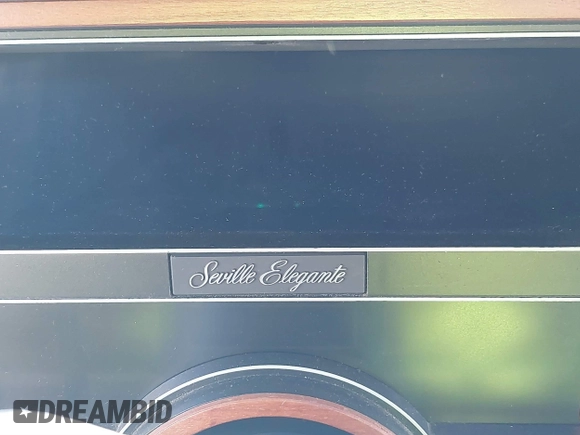 1986 Cadillac Seville z VIN 1G6KS6989GU813079, wystawiony jako IAAI lot #41732353 z przebiegiem Nie podano mil oraz . Historia ofert i sprzedaży dostępna na DreamBid. Obrazek 15.
