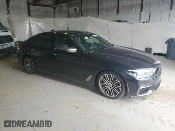 2018 BMW 5 Series M550i xDrive with VIN WBAJB9C58JB035267, listed as a Copart auction lot 64616605 with 125,365 mi miles and Clean title. Bid and sale history available at DreamBid. Image 4.