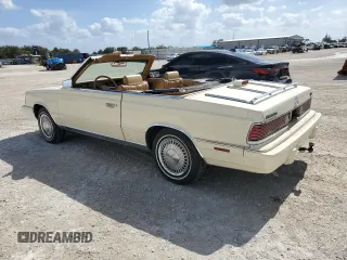1986 Chrysler LeBaron z VIN 1C3BC55D0GG153072, wystawiony jako Copart lot #77865854 z przebiegiem 74 922 mil mil oraz Szkoda całkowita • Salvage title. Historia ofert i sprzedaży dostępna na DreamBid. Obrazek 2.