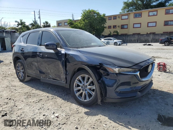2021 Mazda CX-5 Grand Touring with VIN JM3KFBDM4M1462570, listed as a Copart auction lot 54827675 with 45,389 mi miles and Salvage Title. Bid and sale history available at DreamBid. Image 4.