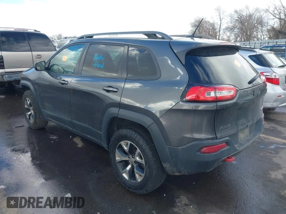 2015 Jeep Cherokee Trailhawk with VIN 1C4PJMBS9FW785545, listed as a IAAI auction lot 41573197 with 124,304 mi miles. Bid and sale history available at carsss.com. Image 3.