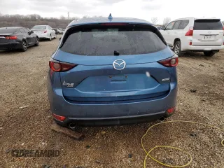2017 Mazda CX-5 Touring z VIN JM3KFBCL2H0129000, wystawiony jako Copart lot #52107005 z przebiegiem 55 411 mil mil oraz Szkody całkowita. Historia ofert i sprzedaży dostępna na DreamBid. Obrazek 6.