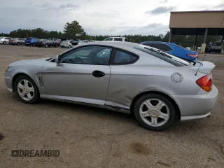 2003 Hyundai Tiburon GT z VIN KMHHN65F13U013420, wystawiony jako Copart lot #51234495 z przebiegiem 230 612 mil mil oraz Szkoda całkowita • Salvage title. Historia ofert i sprzedaży dostępna na DreamBid. Obrazek 2.