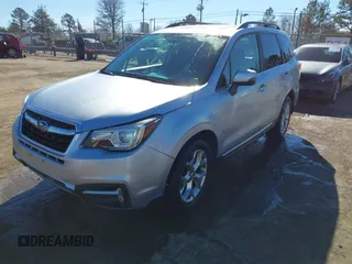 2017 Subaru Forester Touring with VIN JF2SJAWC8HH532348, listed as a IAAI auction lot 41304804 with 104,221 mi miles and . Bid and sale history available at DreamBid. Image 2.
