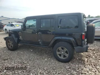 2015 Jeep Wrangler Unlimited Freedom with VIN 1C4BJWDG4FL568601, listed as a Copart auction lot 64041415 with 128,874 mi miles and Salvage title. Bid and sale history available at DreamBid. Image 2.