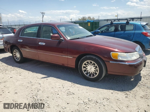 2000 Lincoln Town Car Signature with VIN 1LNHM82W2YY809189, listed as a Copart auction lot 59812665 with 148,236 mi miles and Salvage title. Bid and sale history available at DreamBid. Image 4.
