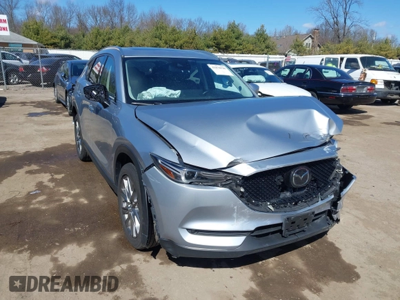 2021 Mazda CX-5 Grand Touring with VIN JM3KFBDM3M1300316, listed as a IAAI auction lot 41878520 with 77,670 mi miles and . Bid and sale history available at DreamBid. Image 1.