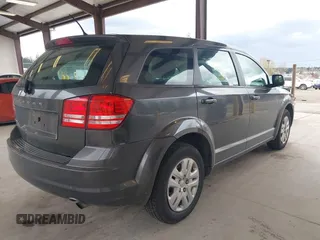 2015 Dodge Journey SE z VIN 3C4PDCAB1FT617794, wystawiony jako IAAI lot #41922371 z przebiegiem 130 558 mil mil oraz . Historia ofert i sprzedaży dostępna na DreamBid. Obrazek 4.