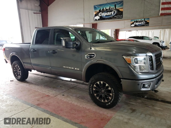 2016 Nissan Titan XD PRO-4X with VIN 1N6BA1F46GN501801, listed as a Copart auction lot 63231474 with 127,728 mi miles and Clean Title. Bid and sale history available at carsss.com. Image 4.