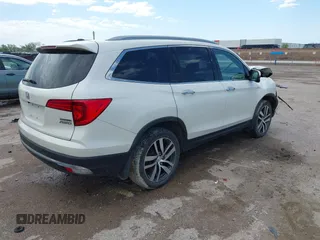 2017 Honda Pilot Touring with VIN 5FNYF6H9XHB034001, listed as a IAAI auction lot 42092549 with 142,422 mi miles and . Bid and sale history available at DreamBid. Image 4.