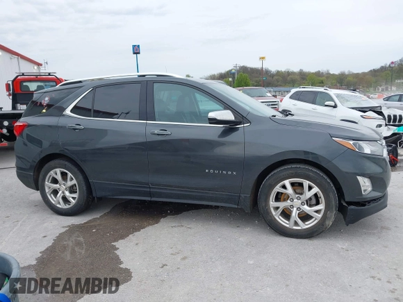 2021 Chevrolet Equinox Premier z VIN 2GNAXNEV9M6140537, wystawiony jako IAAI lot #42016514 z przebiegiem 52 237 mil mil oraz . Historia ofert i sprzedaży dostępna na DreamBid. Obrazek 13.