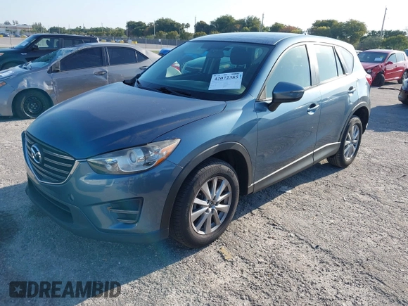 2016 Mazda CX-5 Sport with VIN JM3KE2BY8G0864983, listed as a IAAI auction lot 42072385 with 141,104 mi miles. Bid and sale history available at carsss.com. Image 2.