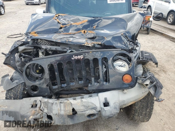 2012 Jeep Wrangler Unlimited Sport z VIN 1C4BJWDG4CL243538, wystawiony jako Copart lot #58826675 z przebiegiem 126 646 mil mil oraz Szkoda całkowita • Salvage title. Historia ofert i sprzedaży dostępna na DreamBid. Obrazek 11.