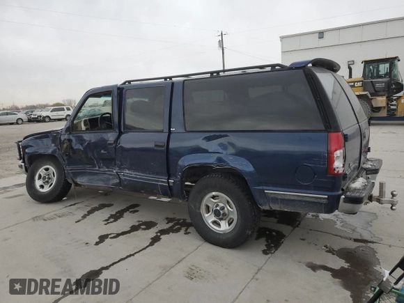 1999 GMC Suburban z VIN 1GDFK16R9XJ771458, wystawiony jako Copart lot #43412175 z przebiegiem 159 328 mil mil oraz Szkody całkowita. Historia ofert i sprzedaży dostępna na DreamBid. Obrazek 2.