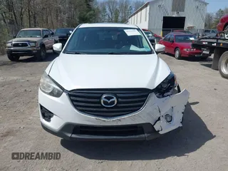 2016 Mazda CX-5 Grand Touring with VIN JM3KE4DY0G0632693, listed as a IAAI auction lot 42123142 with 106,592 mi miles. Bid and sale history available at carsss.com. Image 12.
