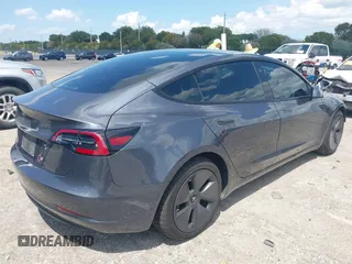 2023 Tesla Model 3 with VIN 5YJ3E1EAXPF575448, listed as a IAAI auction lot 42019288 with 33,859 mi miles and . Bid and sale history available at carsss.com. Image 4.