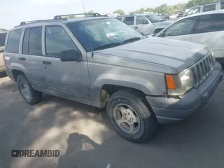 1998 Jeep Grand Cherokee Laredo z VIN 1J4GZ58S6WC319265, wystawiony jako IAAI lot #42619853 z przebiegiem 238 667 mil mil oraz . Historia ofert i sprzedaży dostępna na DreamBid. Obrazek 1.