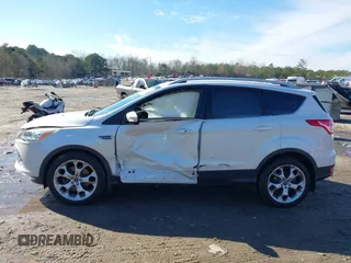 2014 Ford Escape Titanium with VIN 1FMCU9JX7EUD17335, listed as a IAAI auction lot 41302107 with 104,352 mi miles and . Bid and sale history available at DreamBid. Image 13.