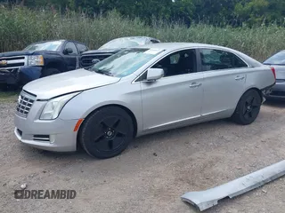 2014 Cadillac XTS Luxury z VIN 2G61N5S38E9270619, wystawiony jako IAAI lot #40140617 z przebiegiem 117 286 mil mil oraz . Historia ofert i sprzedaży dostępna na DreamBid. Obrazek 2.