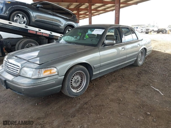 1999 Ford Crown Victoria LX with VIN 2FAFP74W9XX233325, listed as a IAAI auction lot 40934834 with 176,845 mi miles. Bid and sale history available at carsss.com. Image 2.