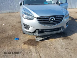 2016 Mazda CX-5 Grand Touring z VIN JM3KE2DY3G0712249, wystawiony jako IAAI lot #37910910 z przebiegiem 262 058 mil mil oraz . Historia ofert i sprzedaży dostępna na DreamBid. Obrazek 6.