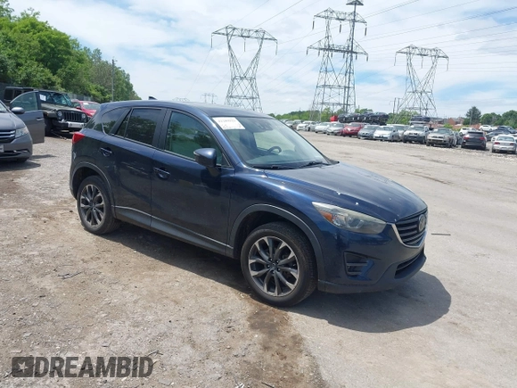 2016 Mazda CX-5 Grand Touring z VIN JM3KE4DY1G0817562, wystawiony jako IAAI lot #42289929 z przebiegiem 135 476 mil mil oraz . Historia ofert i sprzedaży dostępna na DreamBid. Obrazek 1.