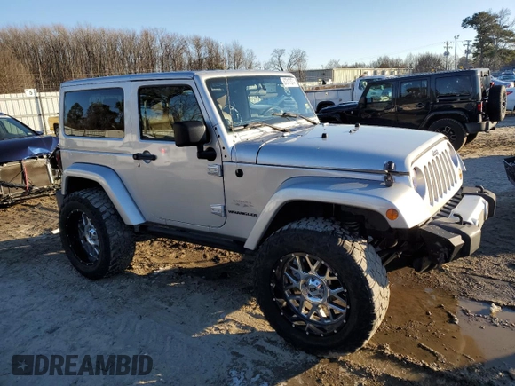 2011 Jeep Wrangler Sahara with VIN 1J4GA5D14BL628876, listed as a Copart auction lot 87317374 with 84,179 mi miles and Salvage Title. Bid and sale history available at DreamBid. Image 4.
