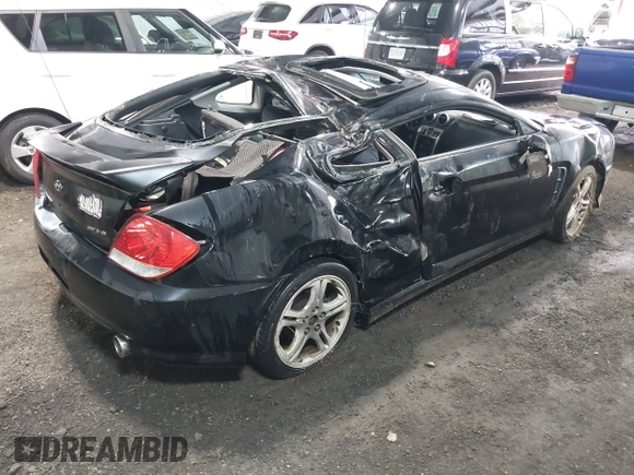 2005 Hyundai Tiburon GT z VIN KMHHN65F45U184777, wystawiony jako IAAI lot #42190342 z przebiegiem 213 013 mil mil oraz . Historia ofert i sprzedaży dostępna na DreamBid. Obrazek 4.