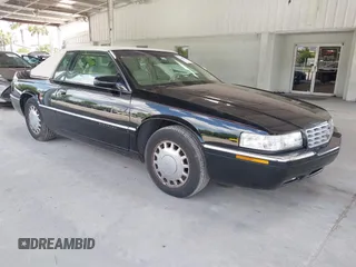 1996 Cadillac Eldorado z VIN 1G6EL12Y7TU607454, wystawiony jako IAAI lot #42490911 z przebiegiem 49 220 mil mil oraz . Historia ofert i sprzedaży dostępna na DreamBid. Obrazek 1.