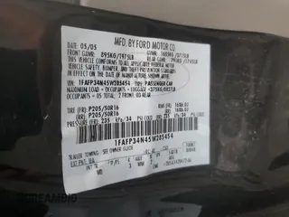 2005 Ford Focus S with VIN 1FAFP34N45W285454, listed as a Copart auction lot 59043485 with 165,071 mi miles and Salvage title. Bid and sale history available at DreamBid. Image 12.