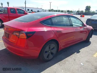 2021 Tesla Model 3 Long Range with VIN 5YJ3E1EBXMF928002, listed as a IAAI auction lot 42003092 with 25,867 mi miles. Bid and sale history available at carsss.com. Image 3.