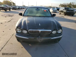 2004 Jaguar X-Type with VIN SAJEA51C24WE14915, listed as a Copart auction lot 77828734 with 0 mi miles and Salvage Title. Bid and sale history available at carsss.com. Image 5.